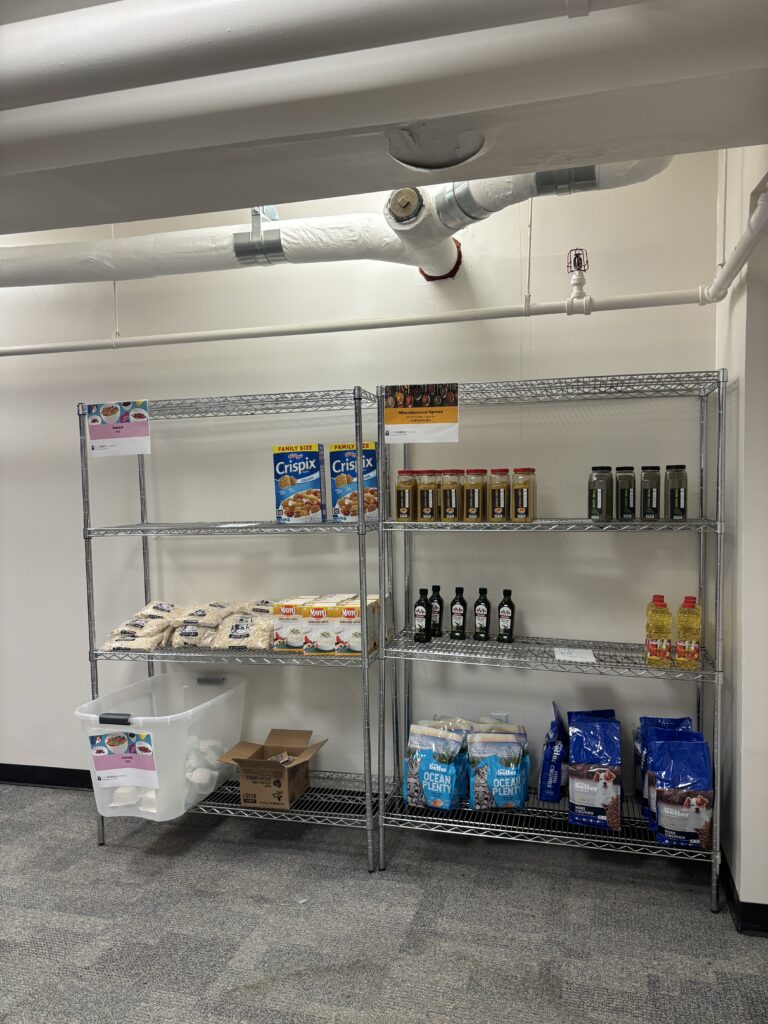 Photo of the cereal, oats, grits, olive oil, pet food, and spices section of the food pantry. 
