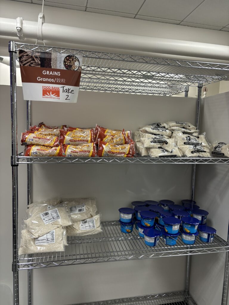 Photo of the grains section of the pantry, including varieties of rice and microwave mac and cheese. 
