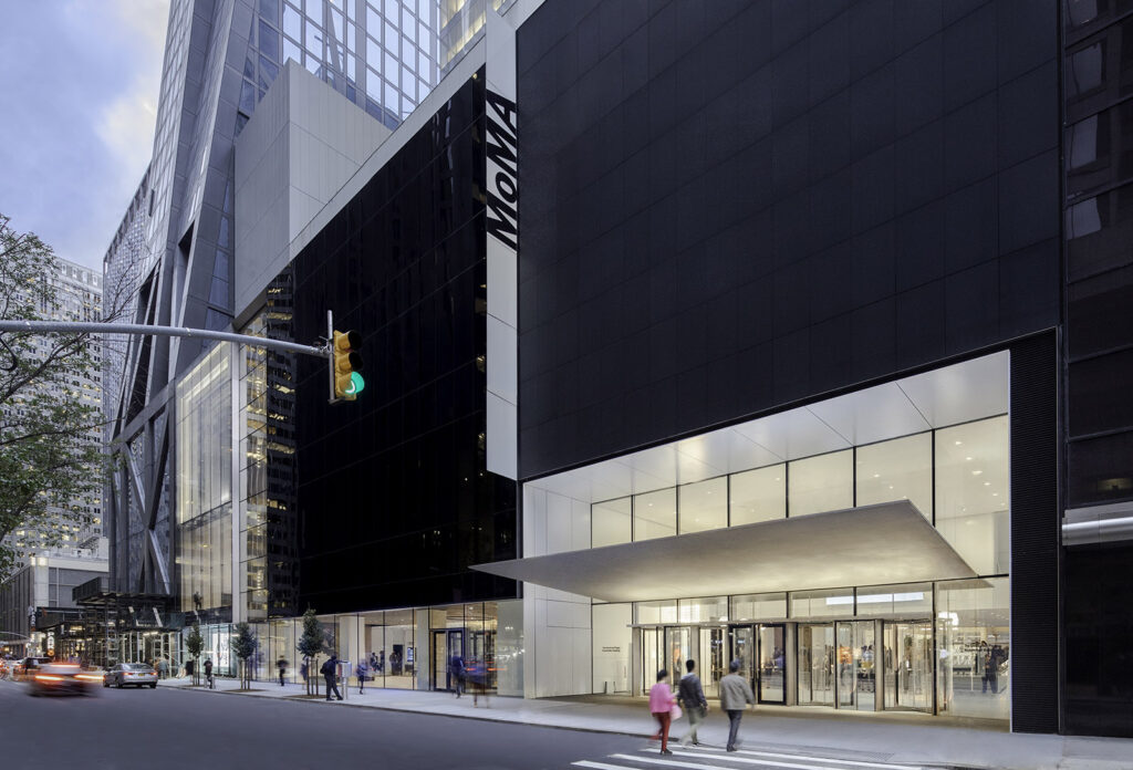 This is a picture of the entrance and street of where the MoMA in Manhattan is located. 